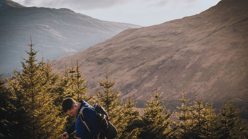 Rear view of man standing on mountain