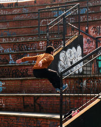 Man on staircase by building