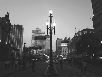 People walking in city at night