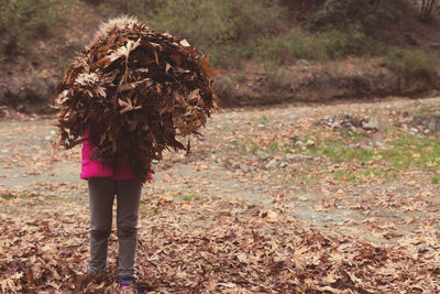 Rear view of woman walking in forest