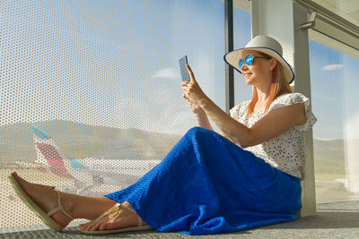 Side view of young woman using mobile phone