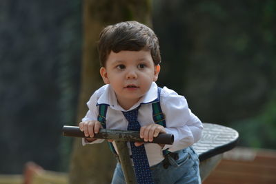 Portrait of boy holding outdoors