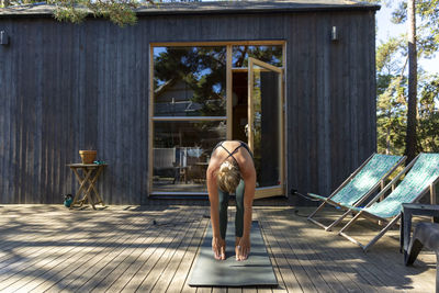 Woman practicing yoga on patio