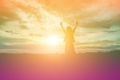 Silhouette person standing against sky during sunset