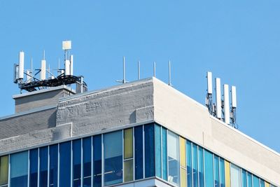 Low angle view of building against clear blue sky