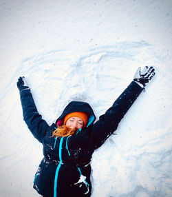 Portrait of young woman standing on snow