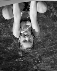 Portrait of woman lying in swimming pool