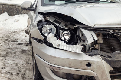 Close-up of damaged car on field