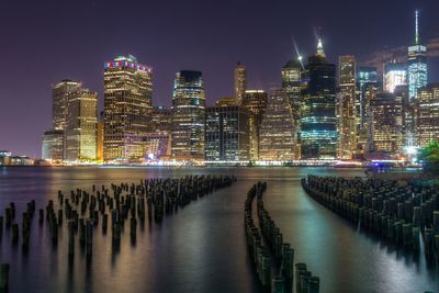 Illuminated city at waterfront