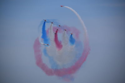 Low angle view of airshow against sky