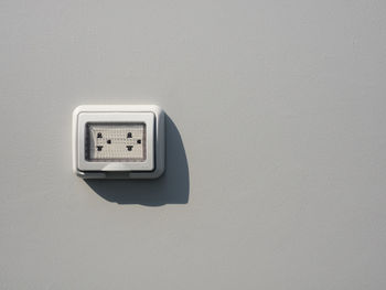 Close-up of telephone booth on wall at home