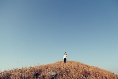 Silhouette of woman against clear blue sky