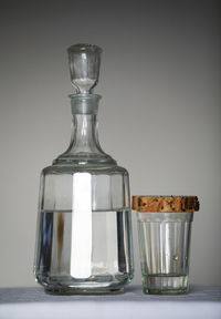 Close-up of wineglass on table against white background