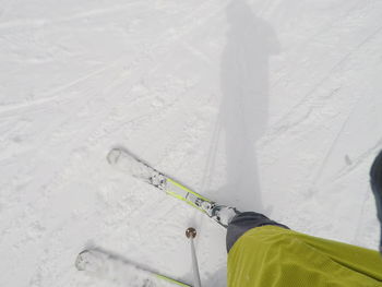 Low section of person skiing on snow