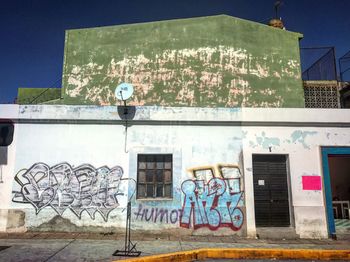 Graffiti on building against sky