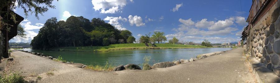 Panoramic view of river amidst trees against sky