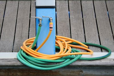 Close-up of yellow pipe on table against wall