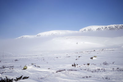 Scenic view of snow covered mountains against sky