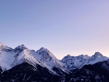 Scenic view of snowcapped mountains against clear blue sky