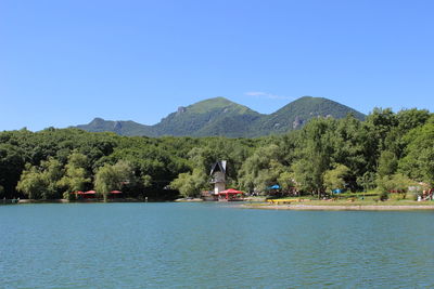 Scenic view of lake against clear blue sky