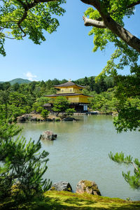 Scenic view of lake by building against clear sky