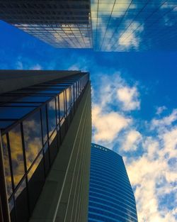 Low angle view of modern building against blue sky