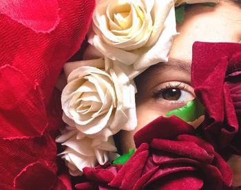 Close-up of woman behind flovers