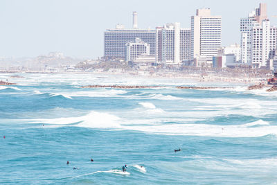 Scenic view of sea and buildings against sky