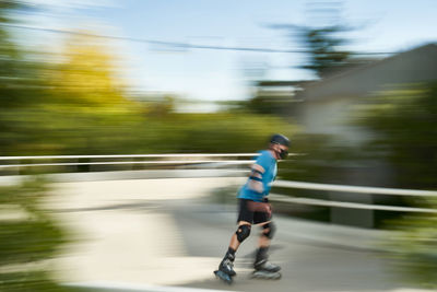 Side view of a senior man rollerblading on blurred motion