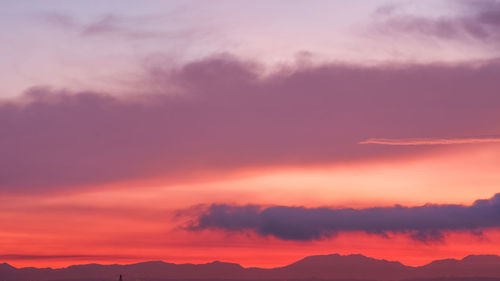 Low angle view of dramatic sky during sunrise