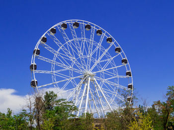 Low angle view of ferris wheel against clear sky