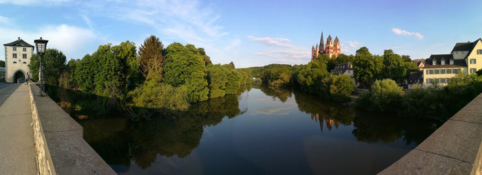 Panoramic view of river and buildings against sky