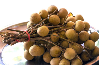 Close up ripe longans on an old wooden background with nature light