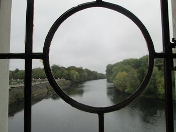 Scenic view of river against sky seen through window