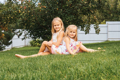 Portrait of a smiling girl sitting on grass