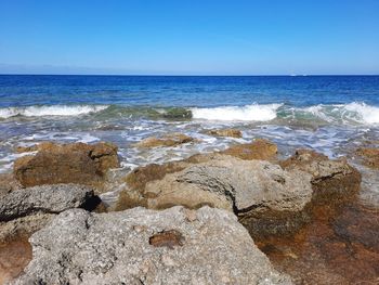 Scenic view of sea against clear blue sky