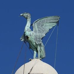 Low angle view of statue against clear blue sky