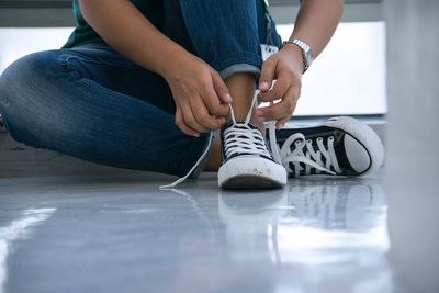 Low section of woman sitting on floor