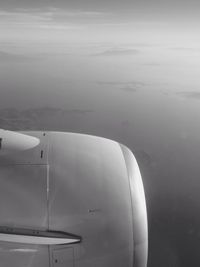 Cropped image of airplane flying against sky