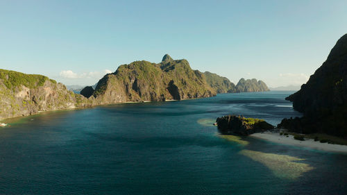 Seascape with tropical rocky islands, ocean blue water, aerial view . 