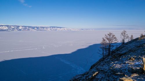 Scenic view of mountains against blue sky