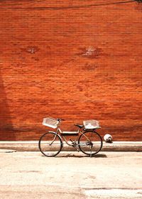 Bicycle parked against wall