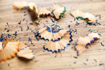 Close-up of pencil shavings on wooden table