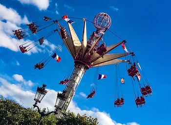 Low angle view of ferris wheel against blue sky