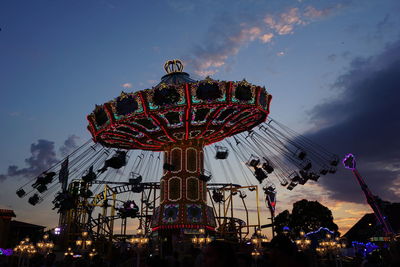 Low angle view of illuminated ferris wheel against sky