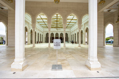 Rear view of man standing in historic building