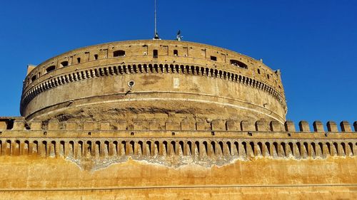 Low angle view of castel sant angelo against clear blue sky
