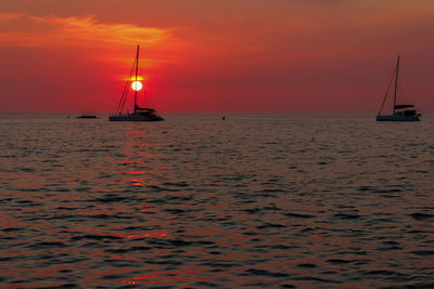 Scenic view of sea against orange sky