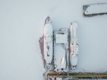 Aerial view of boats moored at frozen harbor