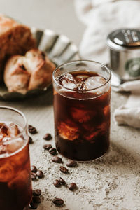 Close-up of drink with ice cubes on table